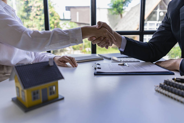 Successful handshake and agreement Real estate agent and client celebrating contracts completed after signing on home insurance and investment loans. house sale ideas - Photo, Image