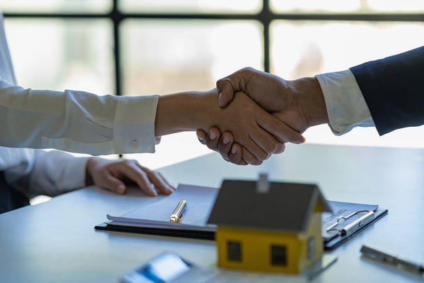 Successful handshake and agreement Real estate agent and client celebrating contracts completed after signing on home insurance and investment loans. house sale ideas - Photo, Image