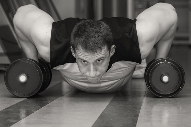 Man doing exercise with dumbbells - 写真・画像