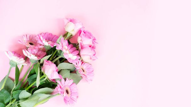 wedding or mothers day background, bouquet of roses and herberas over plain pink background - Foto, afbeelding