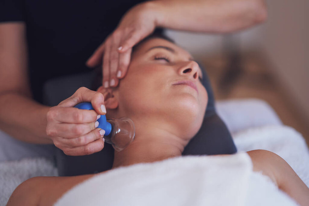 Woman having a face cupping massage in salon. High quality photo - Photo, Image