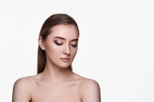 beautiful young woman with closed eyes and perfect skin on white background. copy space - Valokuva, kuva