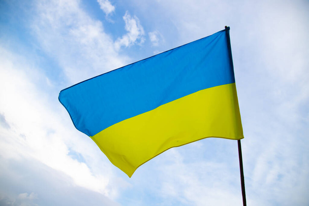 Flag of Ukraine waving in the wind on a clear day. Democracy and politics.  - Foto, Bild