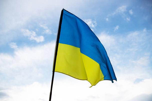 Flag of Ukraine waving in the wind on a clear day. Democracy and politics.  - Foto, Bild
