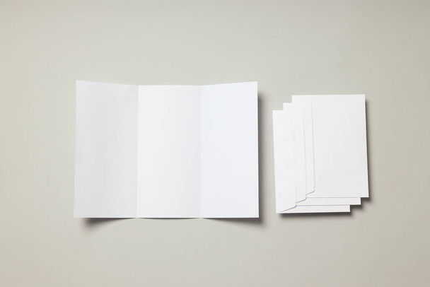 Blank white sheet and envelopes on light gray background - Photo, Image