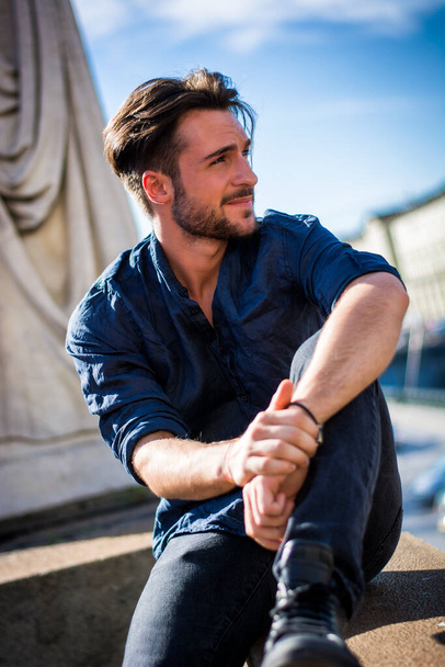 One handsome young man in urban setting in European city, Turin in Italy - 写真・画像