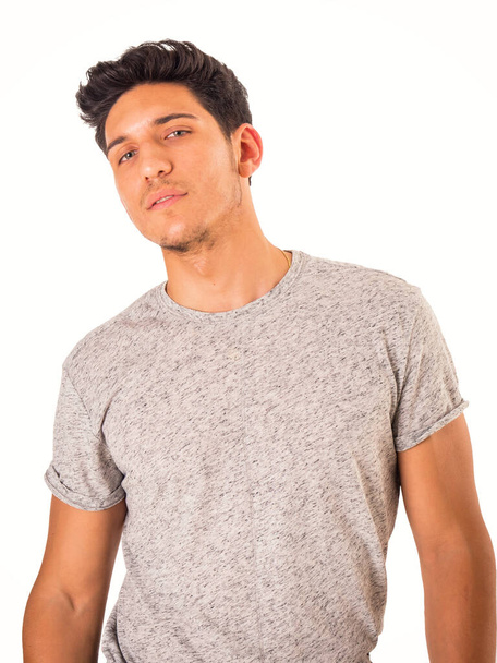 Handsome green eyed young man with grey t-shirt, in studio shot - Фото, изображение