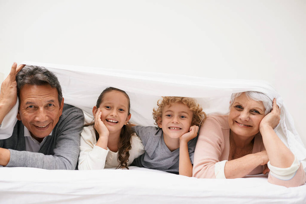 Portrait, grandparents or happy kids in bedroom to relax together for bonding in Australia with love or care. Morning, faces or grandmother with children or mature old man to enjoy quality bed time. - Foto, afbeelding