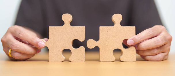Hand connecting couple puzzle piece. Business Solving, mission, challenge, success, goals, target and strategy concepts - Fotó, kép