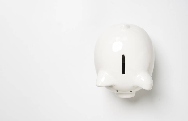 Top view of white piggy bank with copy space for money saving to investment and profit concept. - Valokuva, kuva