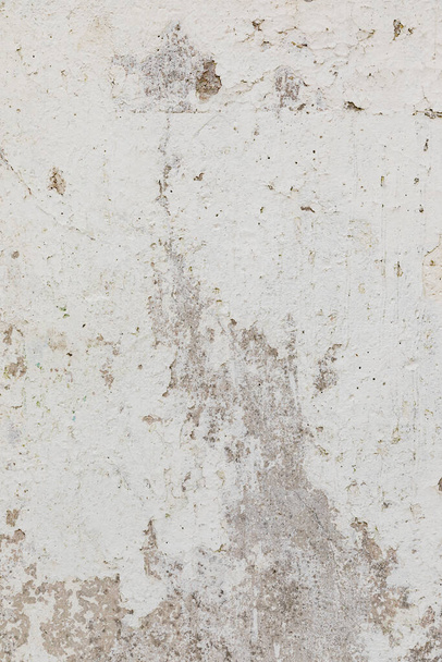 Stucco white aged background. Fragment of a wall in the old town. Vertical - Photo, Image