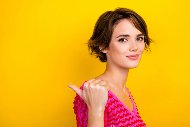 Closeup photo of attractive girl brown hair wear pink crop top direct finger empty space cosmetology beauty salon isolated on yellow color background. - Fotó, kép