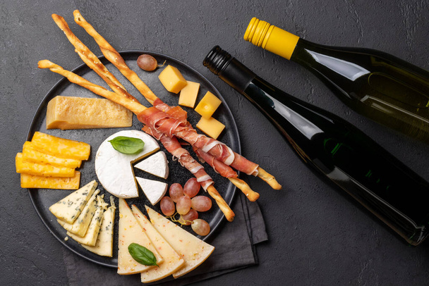 Antipasto board with various cheese and snacks. Flat lay - Foto, imagen