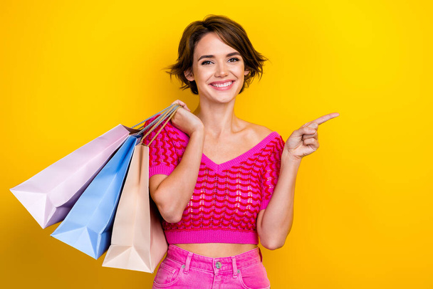 Photo of young promoter bob brown hair girl wear stylish knit outfit direct finger mockup amazon black friday isolated on yellow color background. - Φωτογραφία, εικόνα
