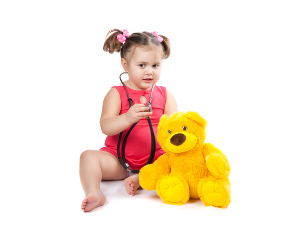 little girl treats toy - Фото, зображення