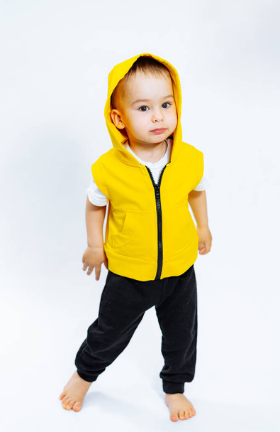 Adorable cheerful kid on white background. Cute little child posing in studio. - 写真・画像
