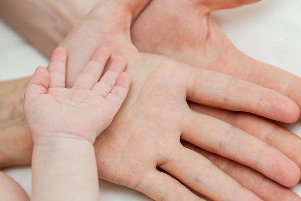 Baba ve anne çocuğun elini tutarak - Fotoğraf, Görsel