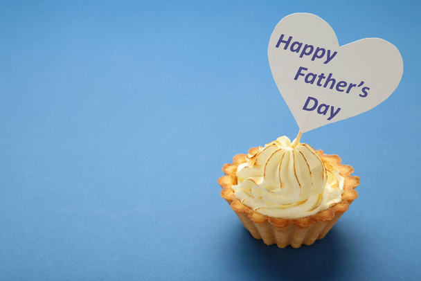 Father's day message with a cupcake on dark blue background. Top view - Фото, изображение