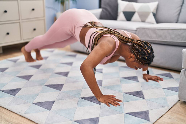African american woman training push up at home - Photo, Image