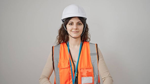 Young beautiful hispanic woman builder smiling confident standing over isolated white background - Фото, изображение