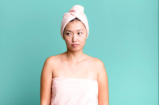 pretty asian woman feeling sad, upset or angry and looking to the side. beauty and shower concept - Fotó, kép