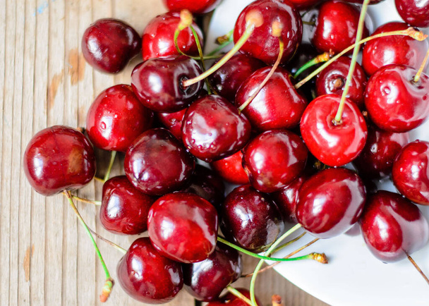 Juicy sweet cherry on old wooden background - Photo, Image