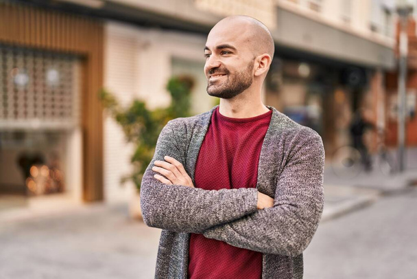 Young man smiling confident standing with arms crossed gesture at street - Photo, Image