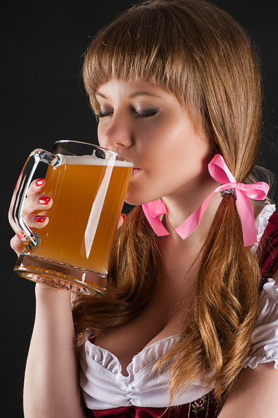 Woman Oktoberfest drinks beer - Fotó, kép