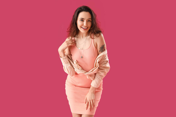 Attractive young woman in dress on pink background - Zdjęcie, obraz
