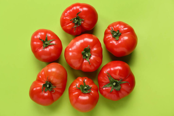 Fresh tomatoes on green background - Фото, зображення