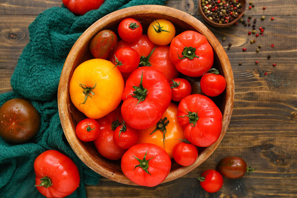 Bowl eri tuoreita tomaatteja puinen tausta - Valokuva, kuva