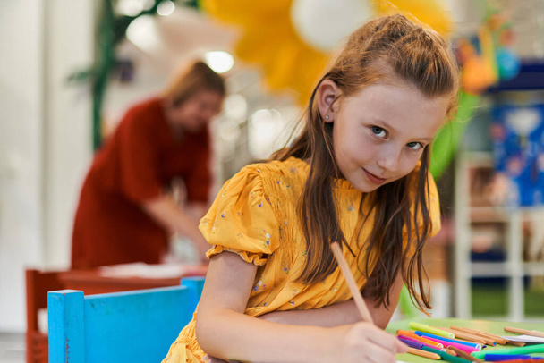 Creative kids sitting in a preschool institution, draw and have fun while they get an education. High quality photo - Фото, зображення