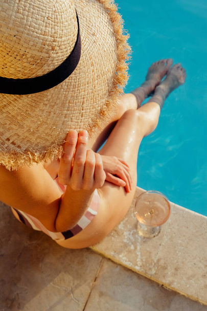 Portrait of laughing beautiful woman in swimwear relaxing in swimming spa pool. - Foto, imagen