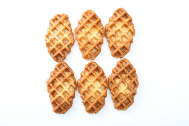 A waffle is a dish made from leavened batter or dough that is cooked between two plates that are patterned to give a characteristic size, shape, and surface impression. - Foto, afbeelding