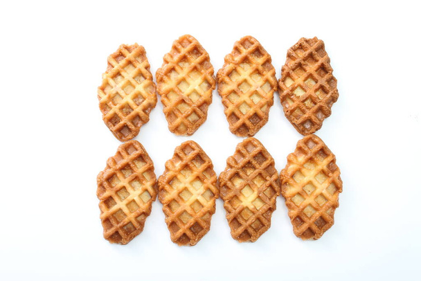A waffle is a dish made from leavened batter or dough that is cooked between two plates that are patterned to give a characteristic size, shape, and surface impression. - Foto, afbeelding