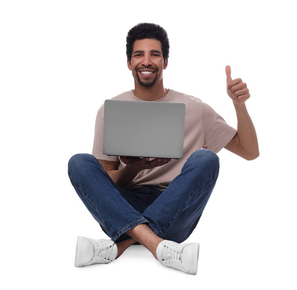 Happy man with laptop showing thumb up on white background - Zdjęcie, obraz