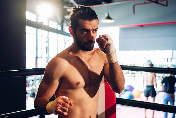 Boxer training in Boxing Club. Boxing fighters training at gym. Strong muscular Man practicing box in gym. - Φωτογραφία, εικόνα