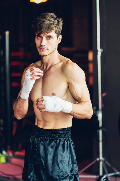 Boxer training in Boxing Club. Boxing fighters training at gym. Strong muscular Man practicing box in gym. - Foto, afbeelding