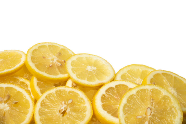 overlapping lemon slices on white background with copy space - Фото, изображение