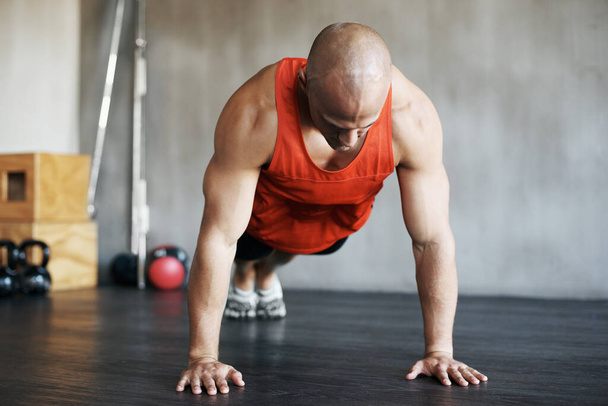 Fitness workout, muscular and strong man doing push up for exercise, health performance or sports training for bodybuilding. Endurance challenge, determination or exercising person doing floor pushup. - Photo, image
