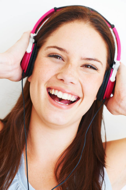 Music headphones, face and woman portrait listening to fun girl song, wellness audio podcast or radio sound. Studio smile, freedom and happy model streaming edm playlist isolated on white background. - Foto, Bild