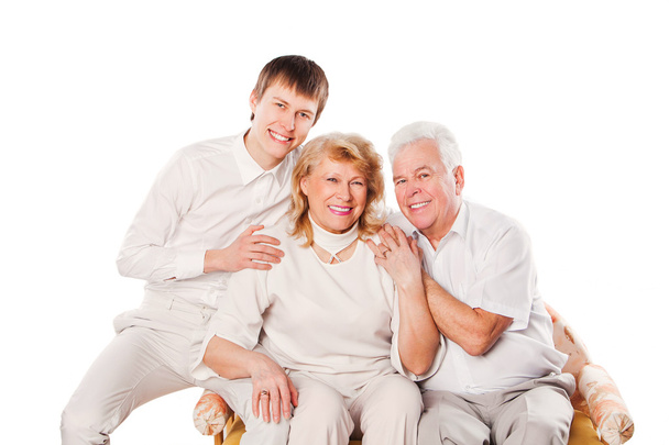 Feliz casal de idosos sorridentes com o filho. Isolado sobre fundo branco
. - Foto, Imagem