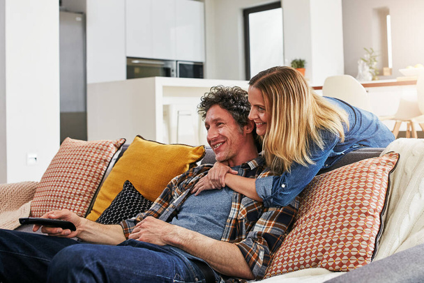 Happy couple, hug and watching tv in home for movie, film show and news broadcast in living room. Mature man, woman and smile on sofa for television series, video subscription and streaming platform. - Φωτογραφία, εικόνα