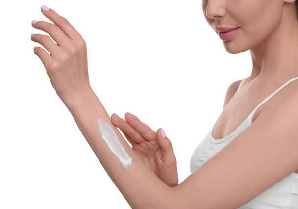 Woman with smear of body cream on her arm against white background, closeup - Valokuva, kuva