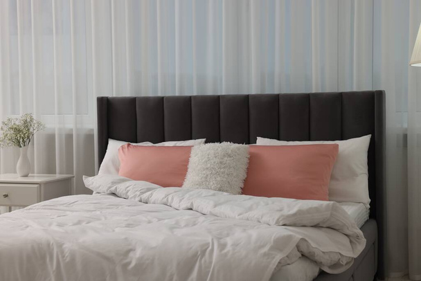 Stylish bedroom interior with comfortable bed and white nightstand - Φωτογραφία, εικόνα