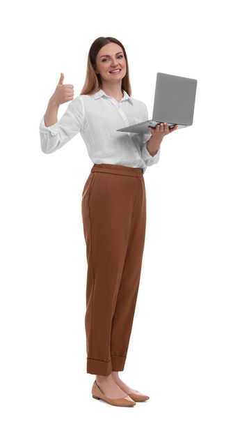 Beautiful businesswoman with laptop showing thumbs up on white background - Фото, изображение