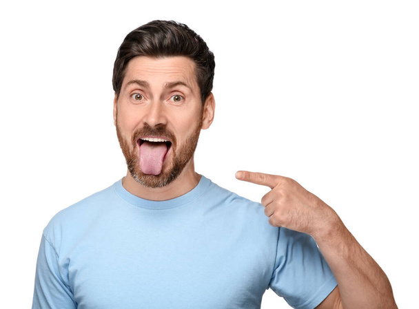 Man showing his tongue on white background - Valokuva, kuva