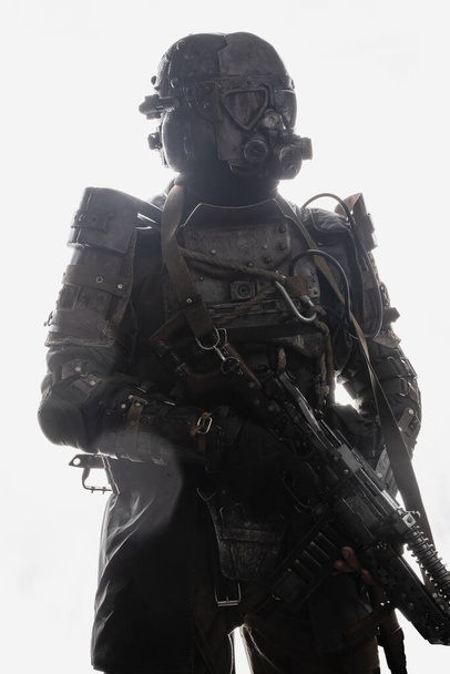 Shot of post apocalyptic survivor with rifle dressed in military uniform. - 写真・画像