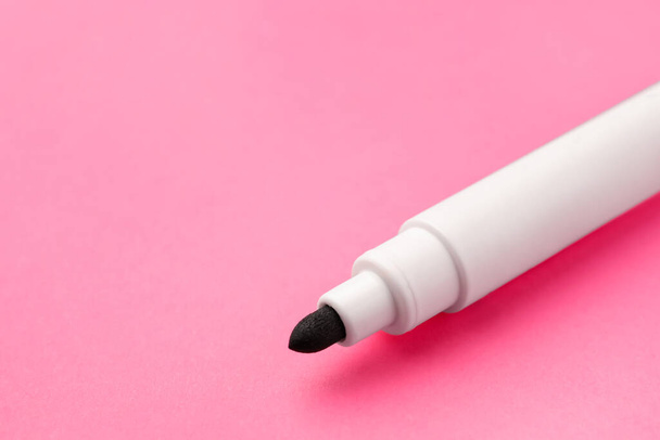 Black marker on pink background, closeup. Space for text - Photo, Image