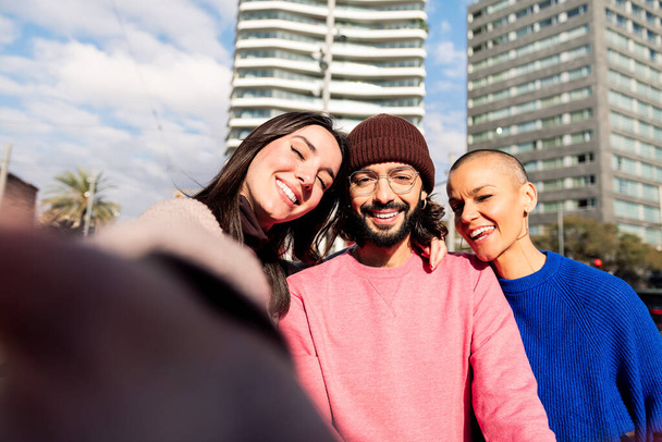 selfie photo of three happy friends smiling in the city, concept of friendship and urban lifestyle - Φωτογραφία, εικόνα